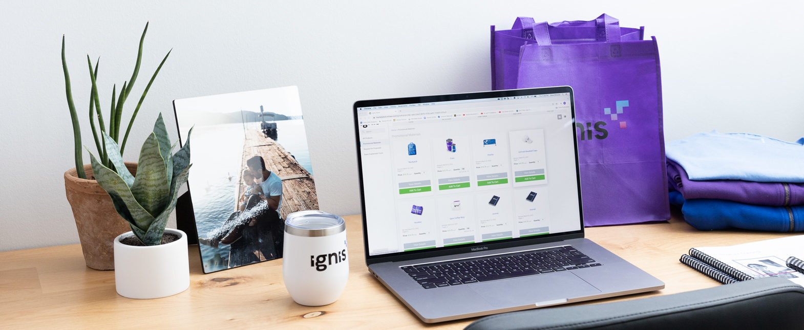 laptop with Mimeo Marketplace Platform surrounded by branded merchandise