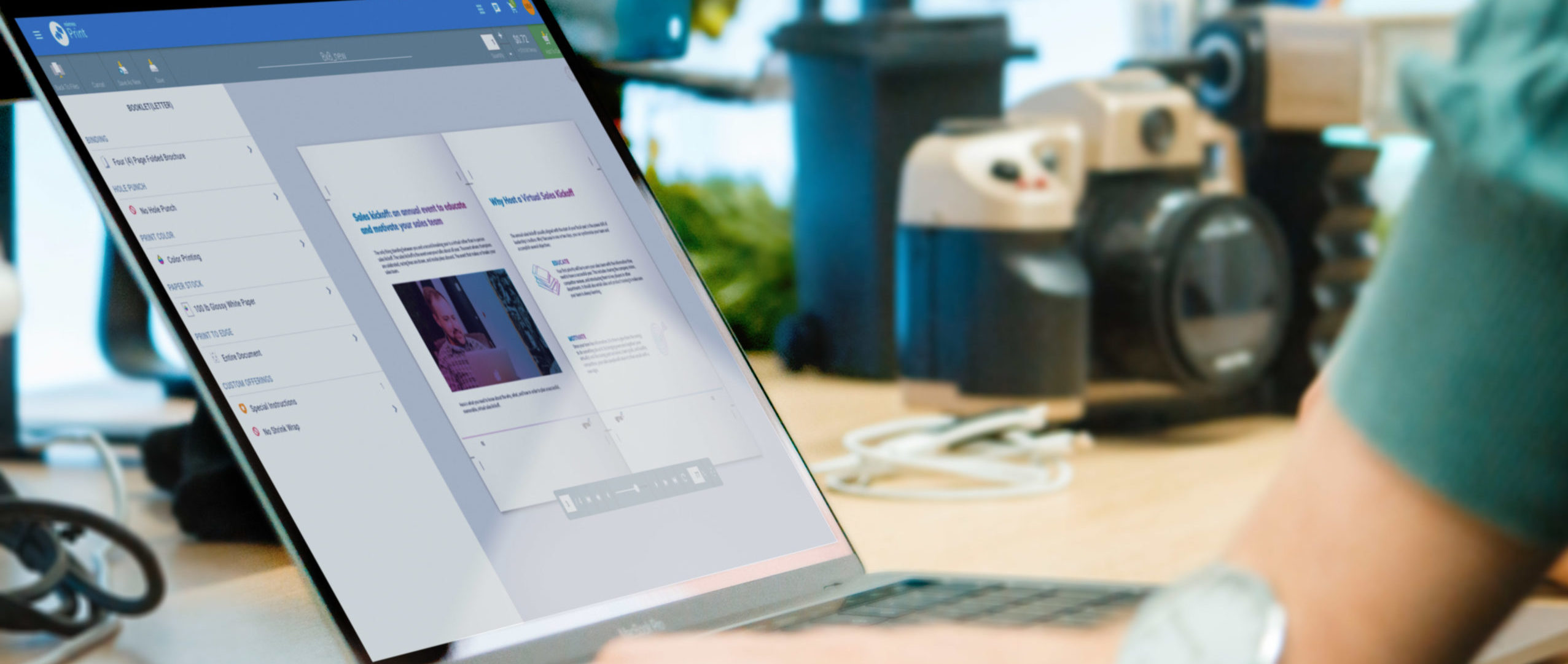 Person using laptop at a desk to view Mimeo Print Platform