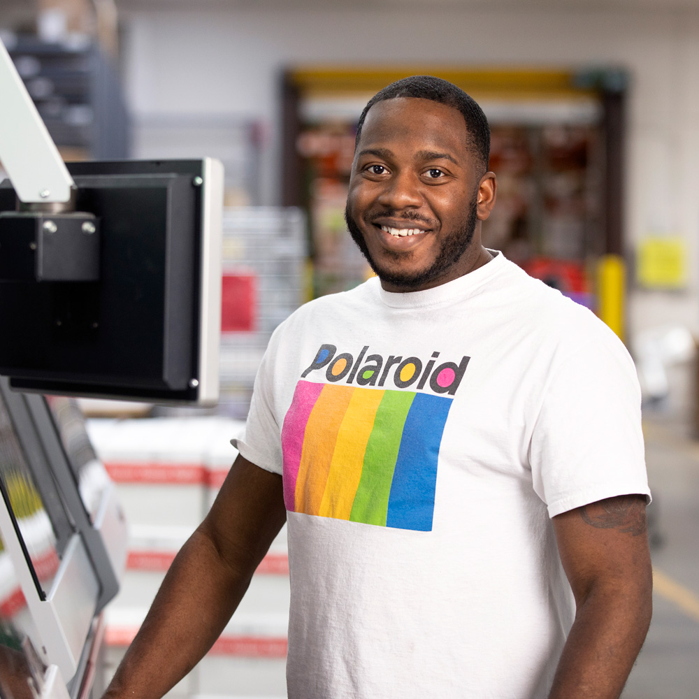 mimeo employee at printer
