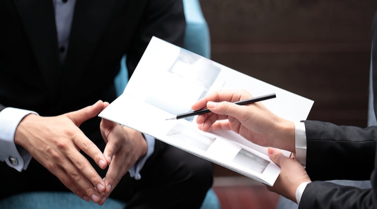 Printing Brochures, Two people making notes on a printed brochure