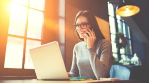 Woman on phone mastering warm calling