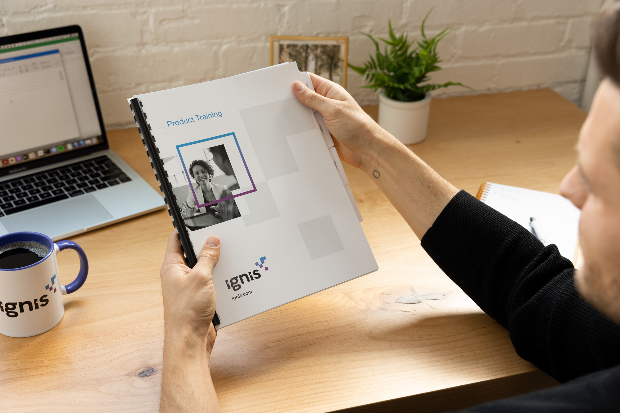 man holding printed bound document