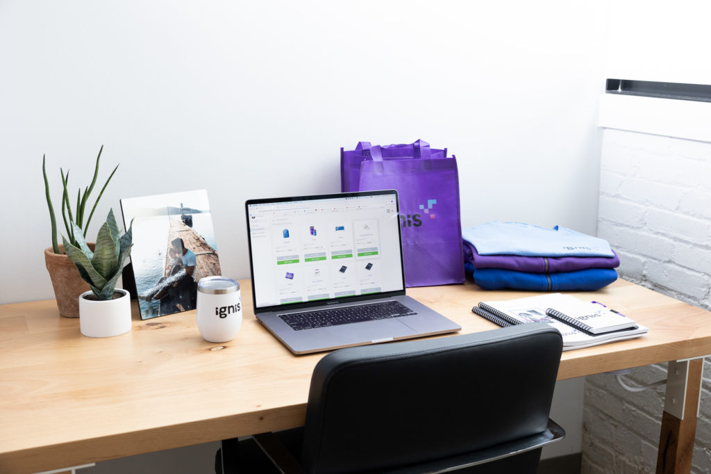 laptop with Mimeo Marketplace Platform surrounded by branded merchandise