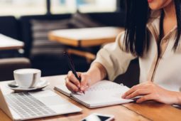 Lifestyle freelance working woman and laptop computer he write book note order in coffee cafe shop