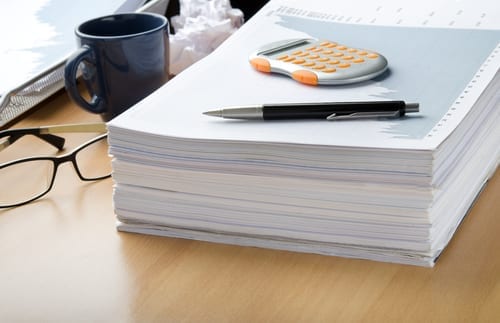 large stack of printed business papers