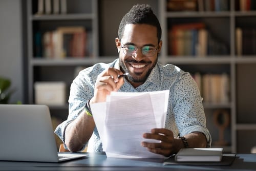 young man reviewing document spacing and layout to save on printing, print budget