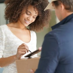 woman signing of package