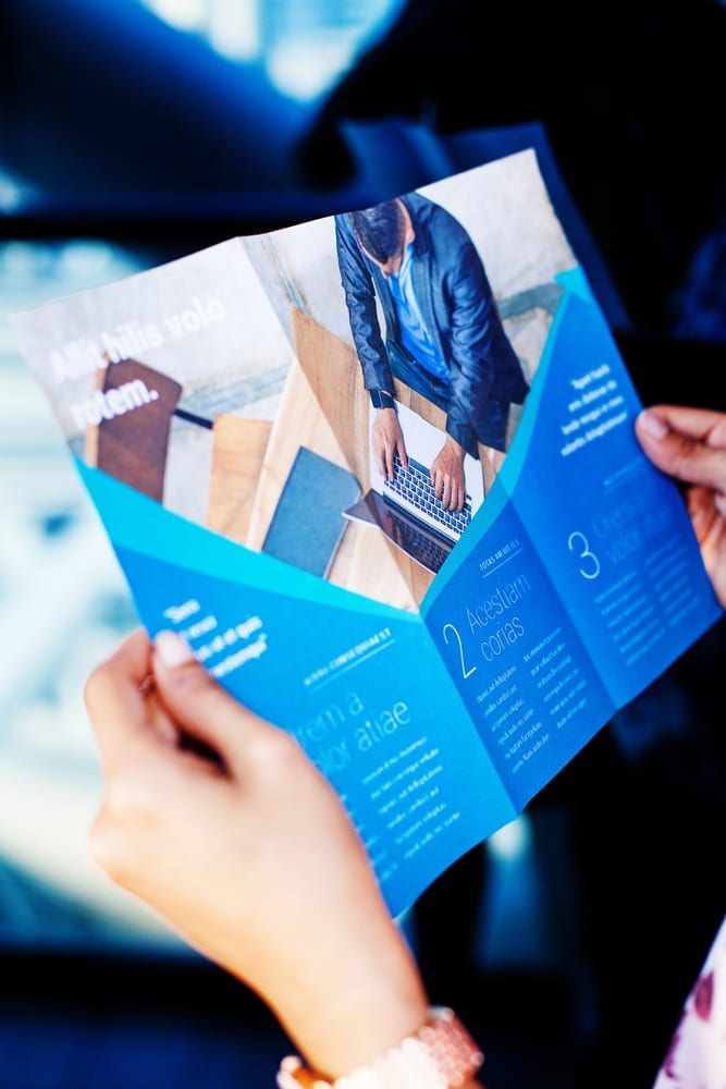 person reading blue booklet