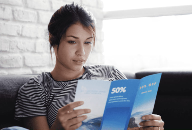 woman reading print brochure