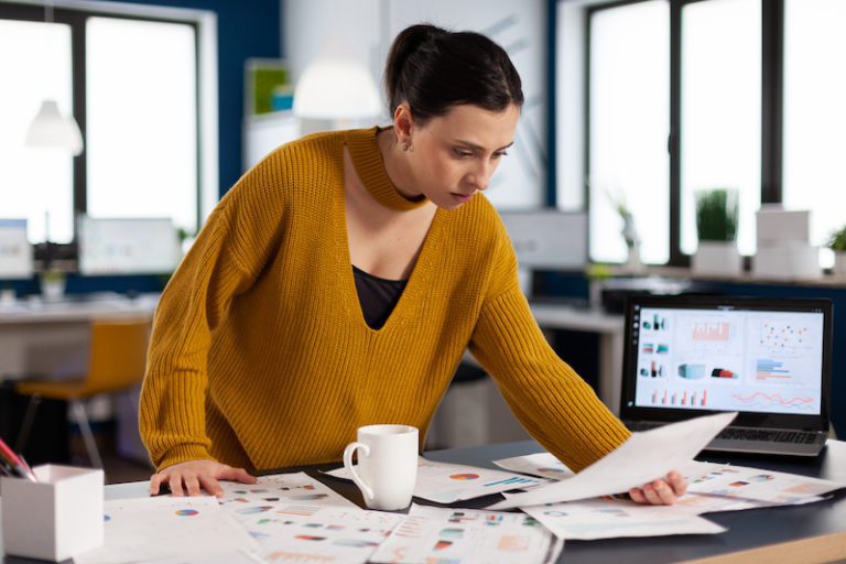 Project leader preparing presenstation for investors using printed charts