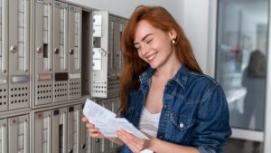 woman holding branded postcards