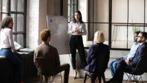 woman leading meeting with presentation