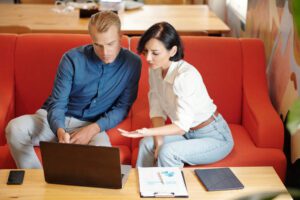 man and woman working on rfp response online