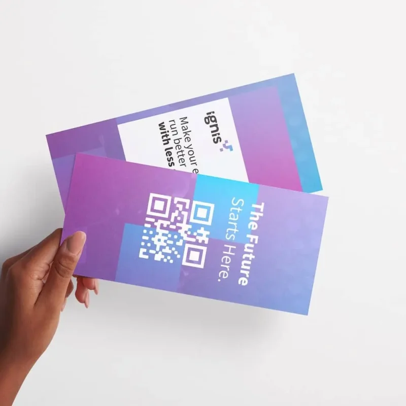 person holding two printed brochures with their hand