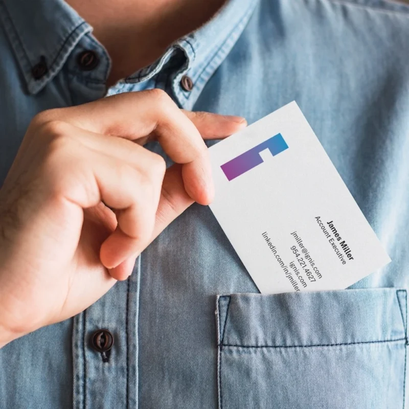 person placing a printed business card in ther pocket